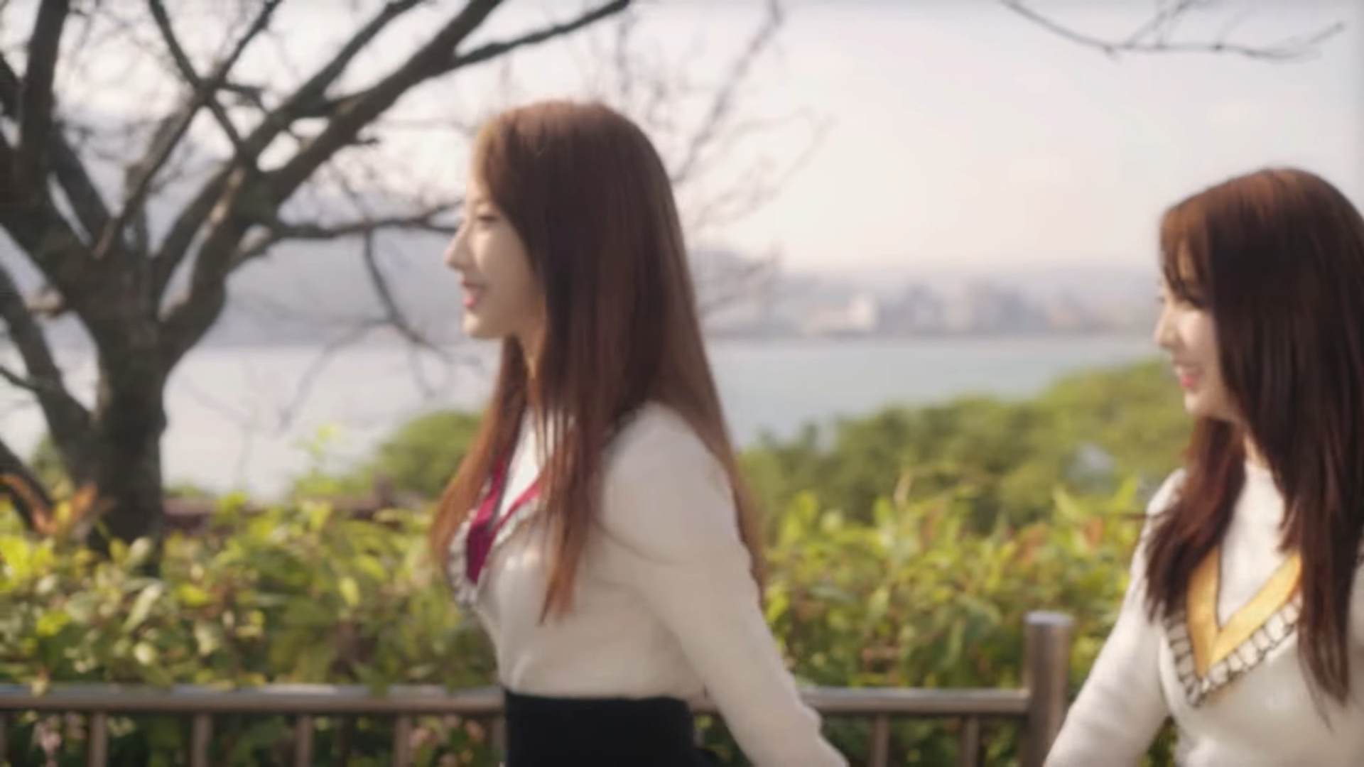 Haseul and Yeojin walking and holding hands.